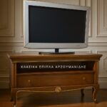 Κλασικό έπιπλο tv KOCHILI σε καφέ απόχρωση στην κύρια φωτογραφία, με μεγάλο ανοικτό τμήμα, χαμηλό συρτάρι και καμπύλα πόδια
