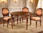 Κλασική τραπεζαρία 904TL με καφέ στρογγυλή επιφάνεια, λεπτά πόδια και καρέκλες με οβάλ πλάτες σε θερμή απόχρωση.